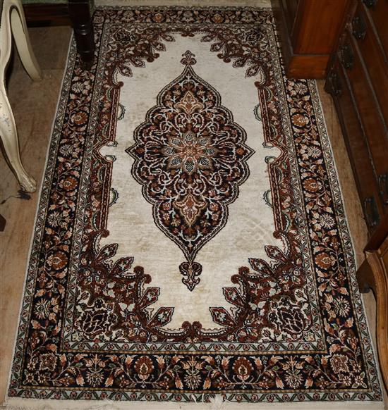A Persian part silk ivory ground rug